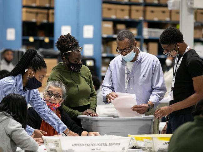 Gwinnett County election workers look over absentee and provisional ballots at the Gwinnett Voter Registrations and Elections office in Lawrenceville, Georgia. Picture: AFP