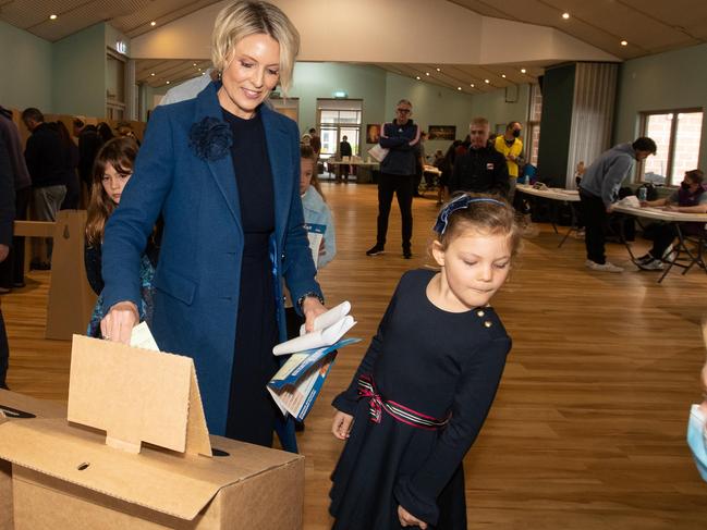 Liberal candidate for Warringah Katherine Deves casts her ballot at 8.30am, with two of her daughters watching on, at St Kieran's Catholic School in Manly Vale. Picture Julian Andrews