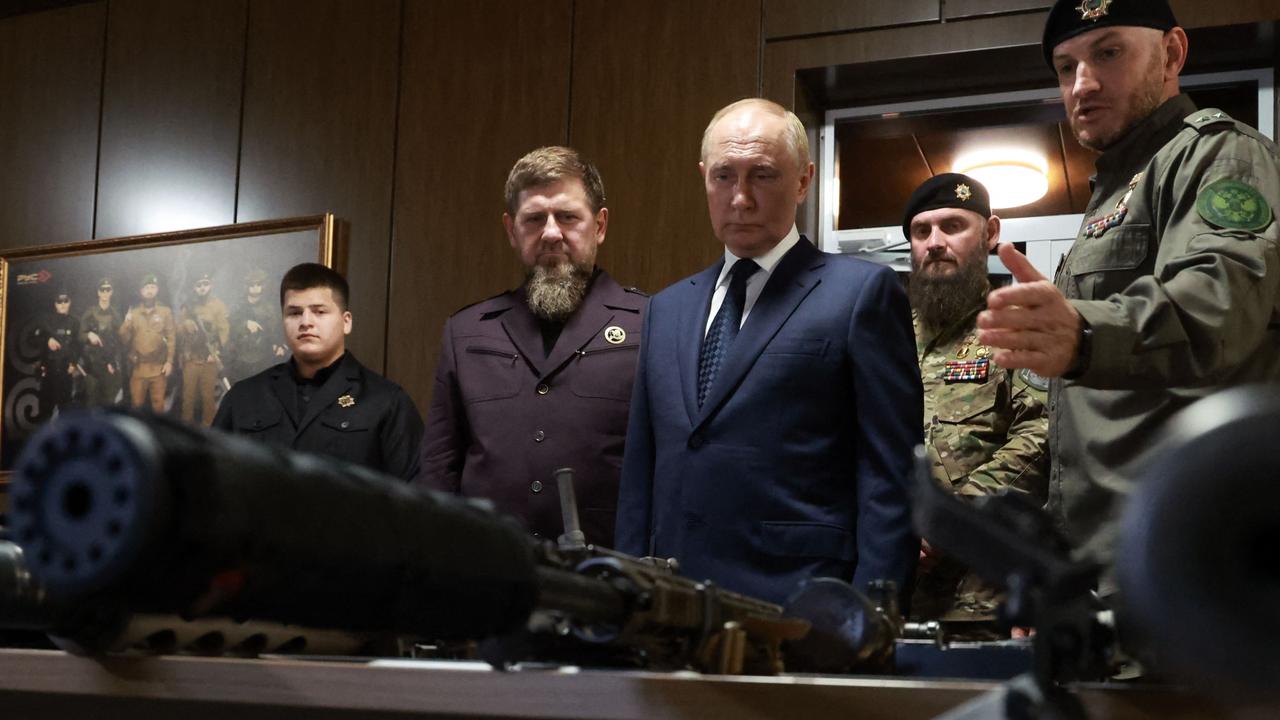 Russian President Putin, centre, inspects weapon at the "Russian Spetsnaz University" special forces training centre in Gudermes on August 20. Picture: Vyacheslav Prokofyev/POOL/AFP/distributed by Russian state-owned agency Sputnik