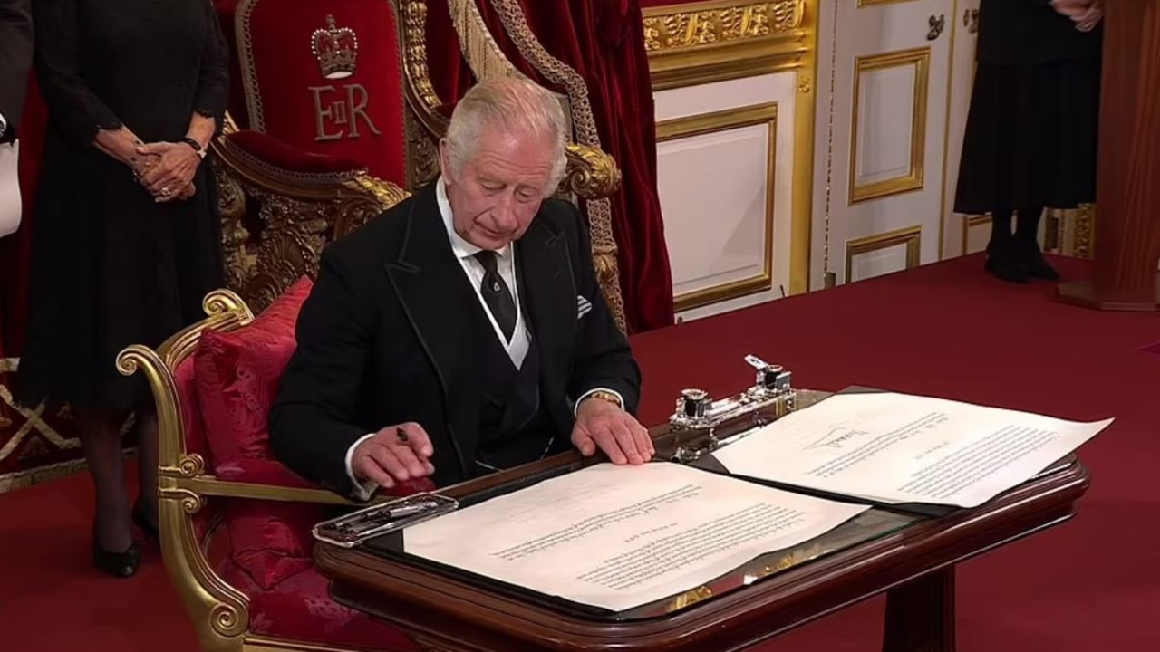 King Charles III signing the proclamation at St James’s Palace in London.