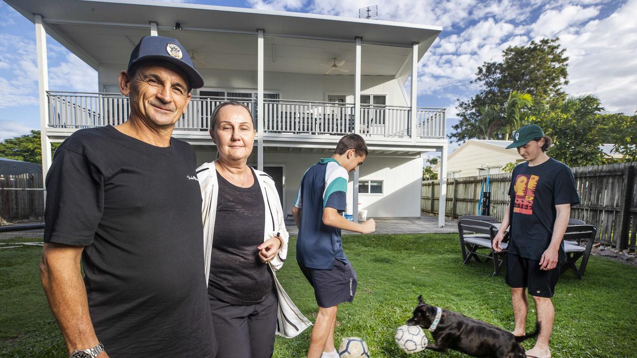 Max and Lee DeLuca with their sons Miles, 14, and Flynn, 19, and dog Brynnie in their back yard at Marcoola. Picture: Lachie Millard