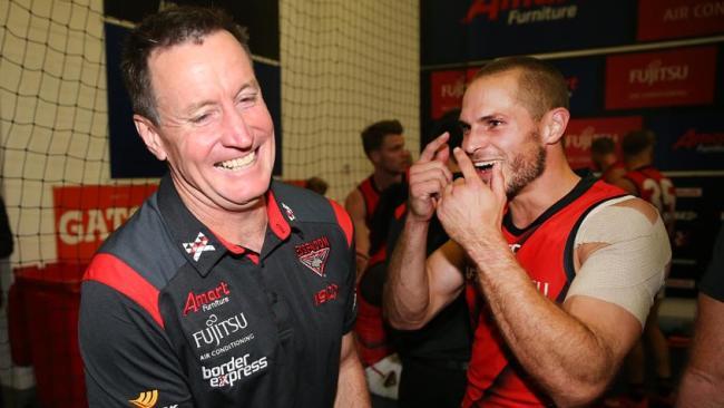 Essendon coach John Worsfold celebrates with Bombers star David Zaharakis.