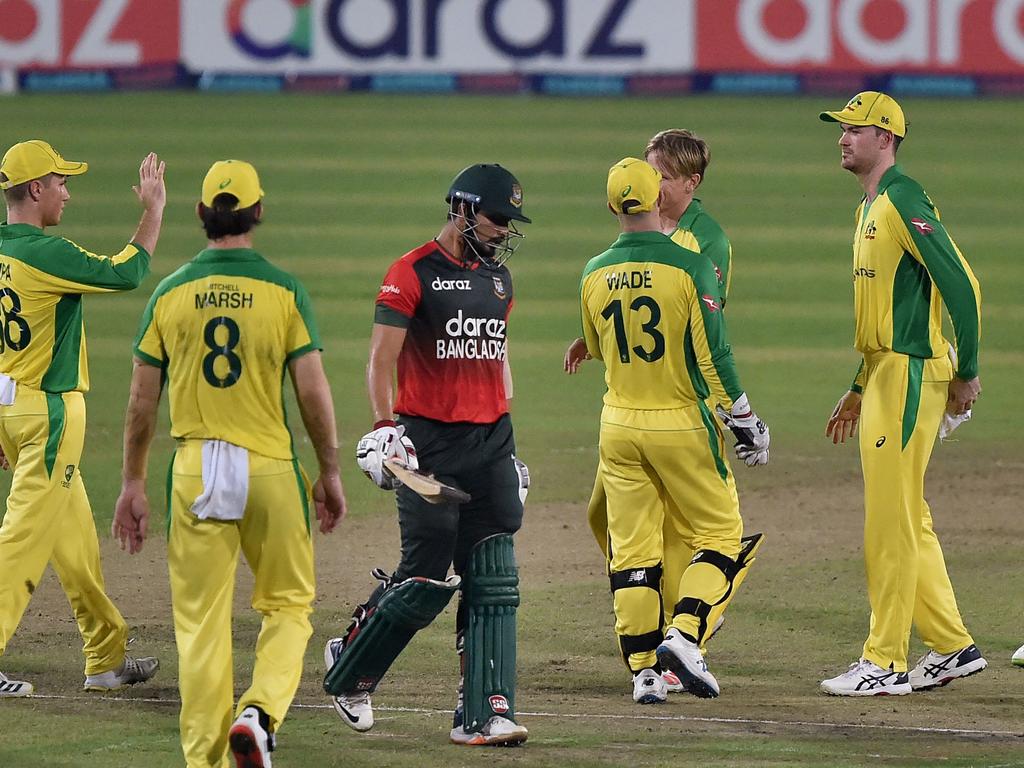 Australia's cricketers celebrate a rare wicket.