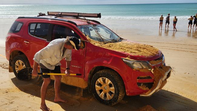 The owners of the car freed it from the sand slide before driving it away in the direction of Rainbow Beach. Pictures: Epic Ocean Adventures Noosa