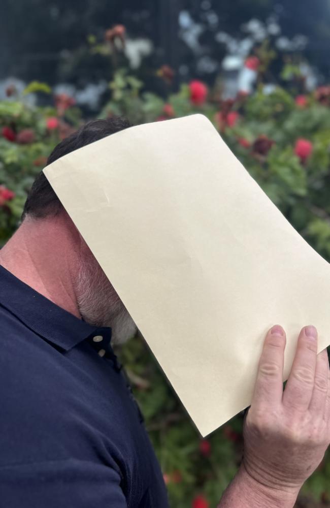 Stevens hiding his face from media following his sentence.