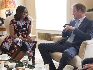 LONDON, ENGLAND - JUNE 16: In this handout photo provided by The White House, US First Lady Michelle Obama meets Prince Harry at Kensington Palace on June 16, 2015 in London, England. The US First Lady is travelling with her daughters, Malia and Sasha and her mother, Mrs. Marian Robinson, to continue a global tour promoting her 'Let Girls Learn Initiative'. The event at the school was to discuss how the UK and USA are working together to expand girl's education around the world. (Photo by Amanda Lucidon/The White House via Getty Images)