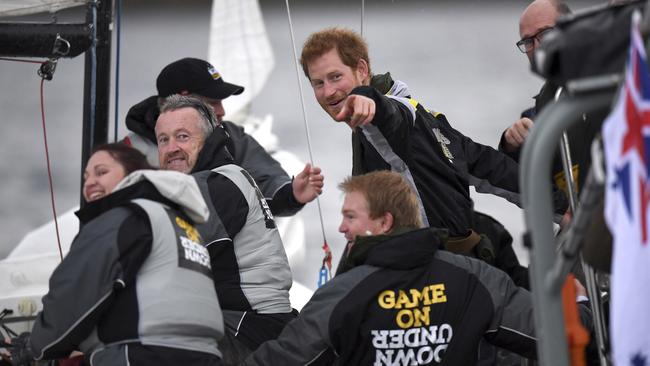 Britain's Prince Harry, center, meets the crew of a sailing boat, foreground, during a demonstration on the harbor in Sydney, Wednesday, June 7, 2017. Prince Harry is in Sydney to launch the 2018 Invictus Games. (Dean Lewins/Pool Photo via AP)