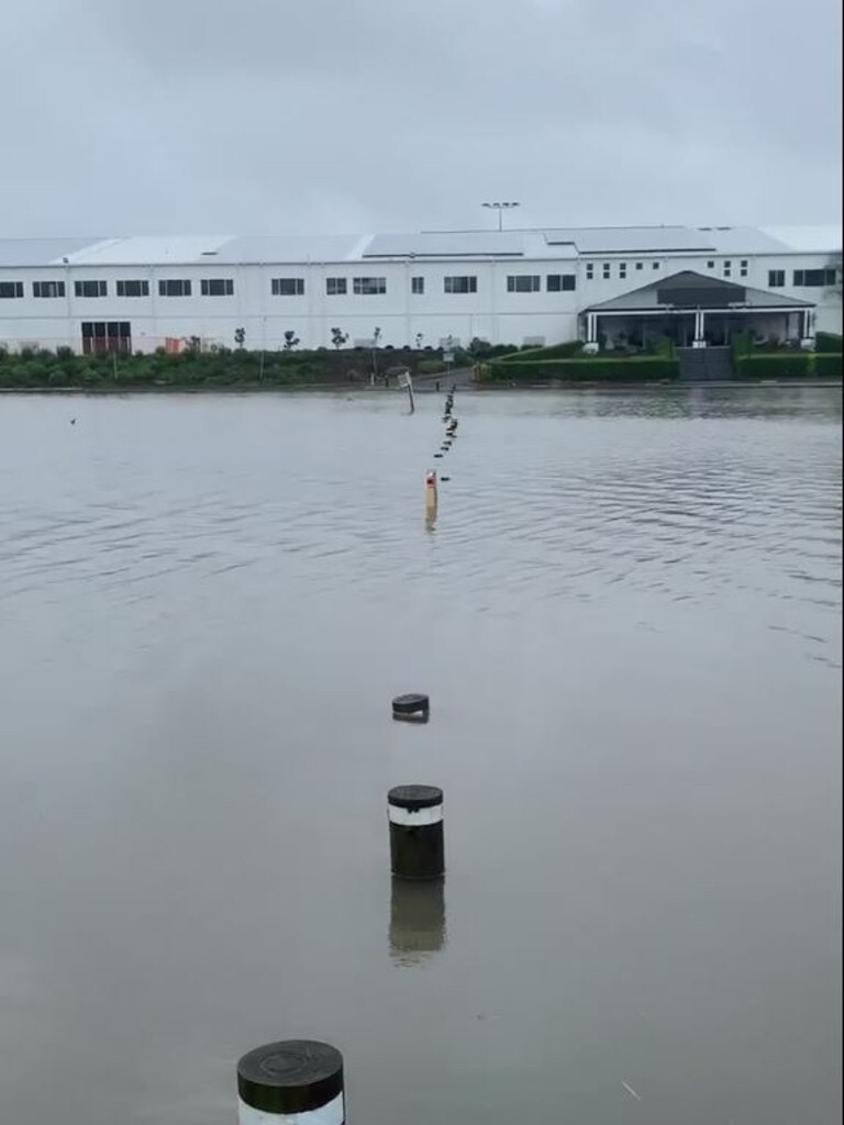 Flooded waters make the carpark at a Carrara church look like a lake. Supplied by Guy Mason.