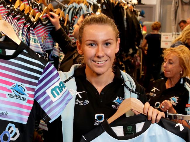 Sales assistant Elana White in the Cronulla Sharks pop up shop which is selling club merchandise in the the Cronulla Sharks club . Picture : Gregg Porteous