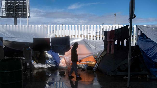 A migrant girl walks at an improvised camp outside El Chaparral crossing port as they wait for US authorities to allow them to start their migration process in Tijuana. Picture: AFP