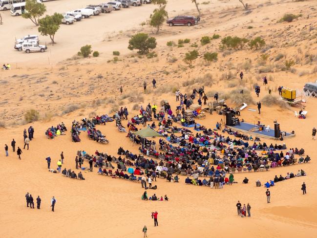 08/07/2013: Crowd gathered atop the Big Red sand dune, in far western Queensland, at the inaugural Big Red Bash in 2013. Country musician John Williamson performed for a group of ultra runners and volunteers associated with an event named Big Red Run. The event gradually grew into a multi-day camping music festival and major tourist attraction. Picture: Jason Malouin