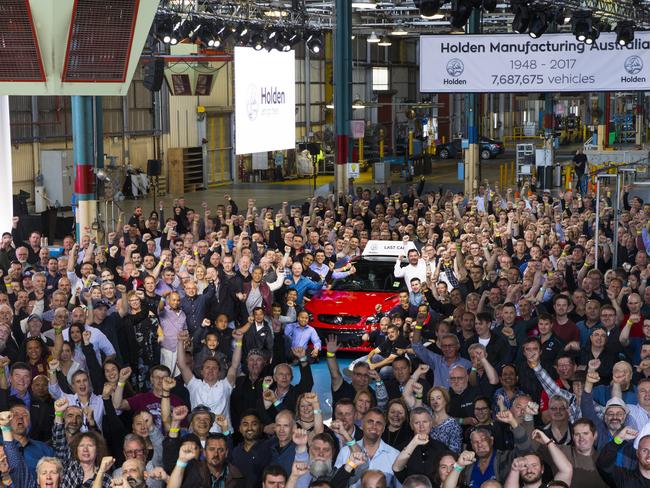 Workers pose with the last Holden. Picture: AAP/Holden Pressroom