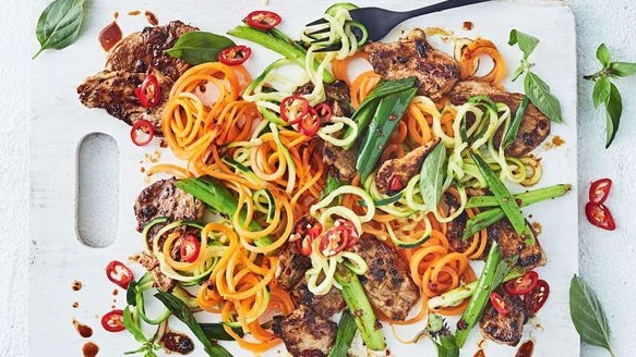 Ginger pork stir-fry with vegetables and noodles.