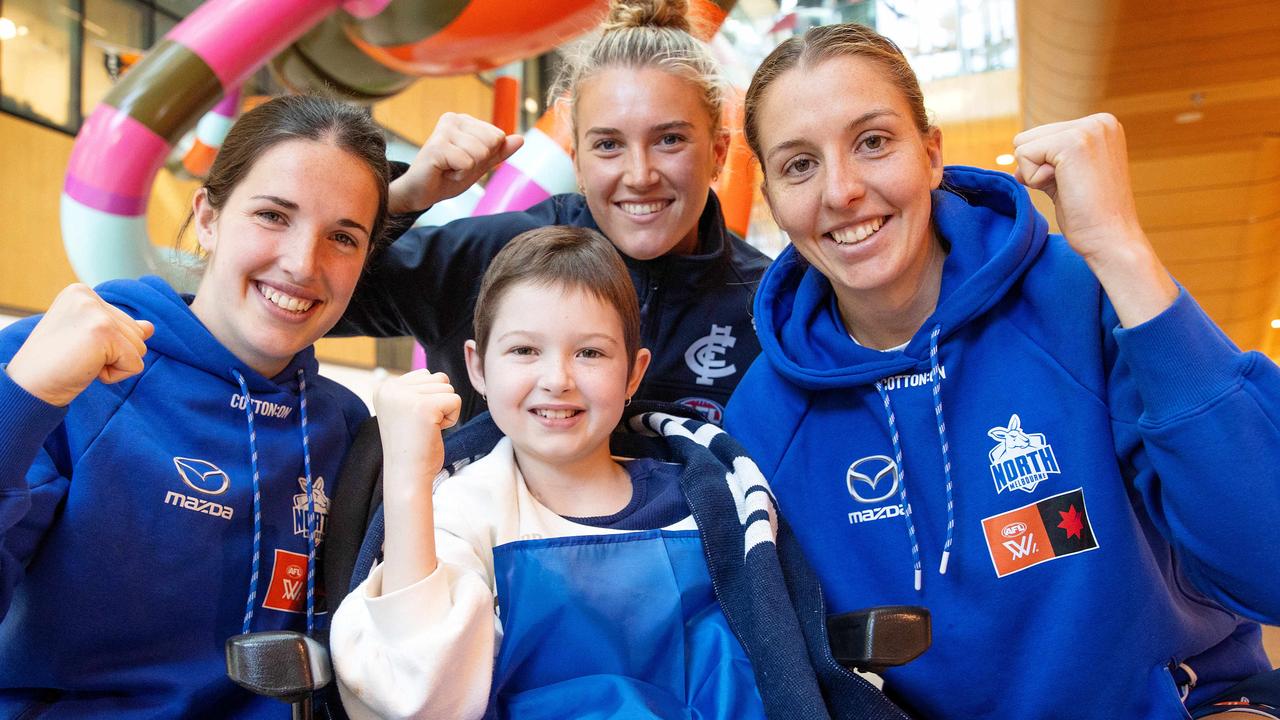 Imogen Mulgrew meets Kangaroos forwards Bella Eddey (left) and Emma King along with Carlton midfielder Abbie McKay at the RCH. Picture: Mark Stewart