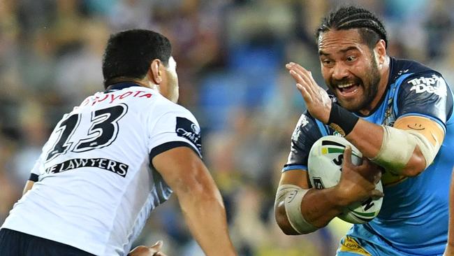 Konrad Hurrell of the Titans is tackled by Jason Taumalolo of the Cowboys during the Round 25 NRL match between the Gold Coast Titans and the North Queensland Cowboys at Cbus Super Stadium on the Gold Coast. Photo: AAP