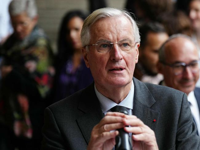 French Prime Minister Michel Barnier speaks to the press during a visit to the "House of Women of the AP-HP" ("Maison des Femmes de l'Assistance Publique - Hopitaux de Paris") in Paris, on November 25, 2024 as part of the International Day for the Elimination of Violence Against Women. (Photo by Dimitar DILKOFF / AFP)