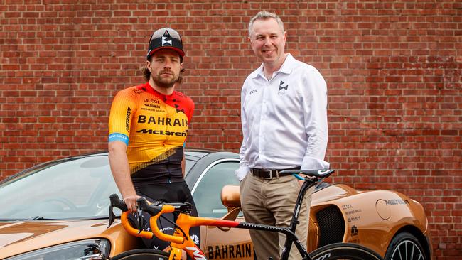 Team Bahrain McLaren director John Allert and rider Marco Haller with a McLaren in Adelaide. Picture: Matt Turner