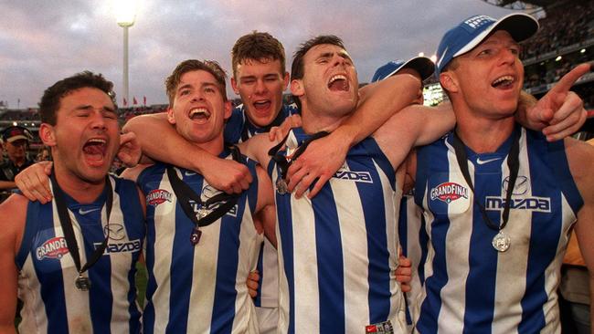 Mooney celebrates his first premiership with Roos teammates.