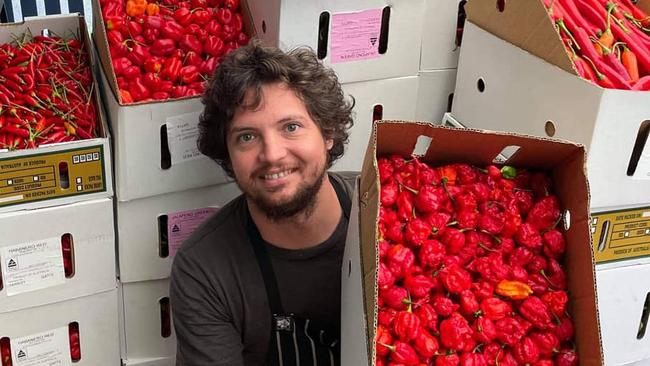 Village Pickle Chili Co co-founder Brendan Chan with the many varieties of chili he uses to make fermented chili sauce. Picture: Supplied