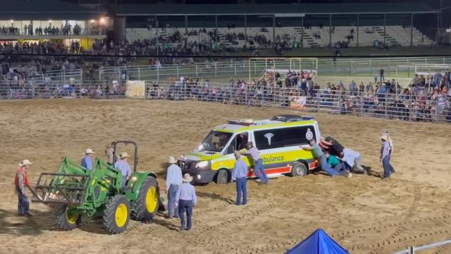 An ambulance is towed out of the arena at the Warwick New Year's Eve Rodeo after a 25-year-old cowboy was critically injured while riding a bull at the event. He later died in hospital.