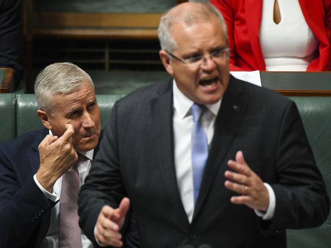 Prime Minister Scott Morrison addresses Question Time yesterday as his deputy and Nationals leader Michael McCormack looks on. Picture: Lukas Coch/AAP