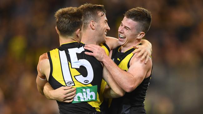 Higgins, right, celebrates Tuesday night’s win with teammates Jayden Short and Kane Lambert. Pic: AAP