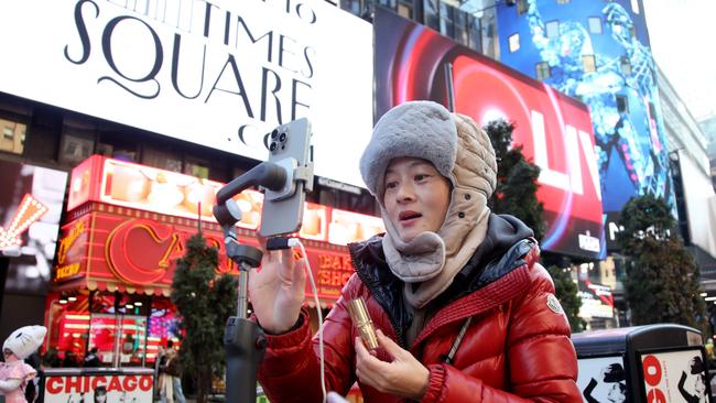 A woman records herself on a smartphone for social media in Times Square in New York City ahead of the US TikTok ban. Picture: Leonardo Munoz/AFP