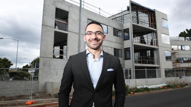 Hobart City Council Alderman Simon Behrakis standing in front of a new multi-residential development in Sandy Bay. Picture: LUKE BOWDEN