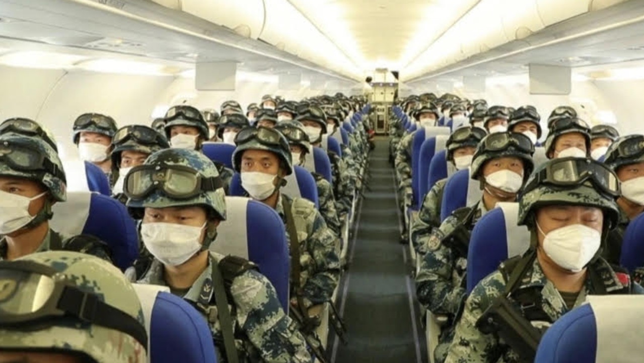 Chinese state media has shown images of a civilian plane full of troops as part of a drill that coincided with an ongoing border conflict with India.