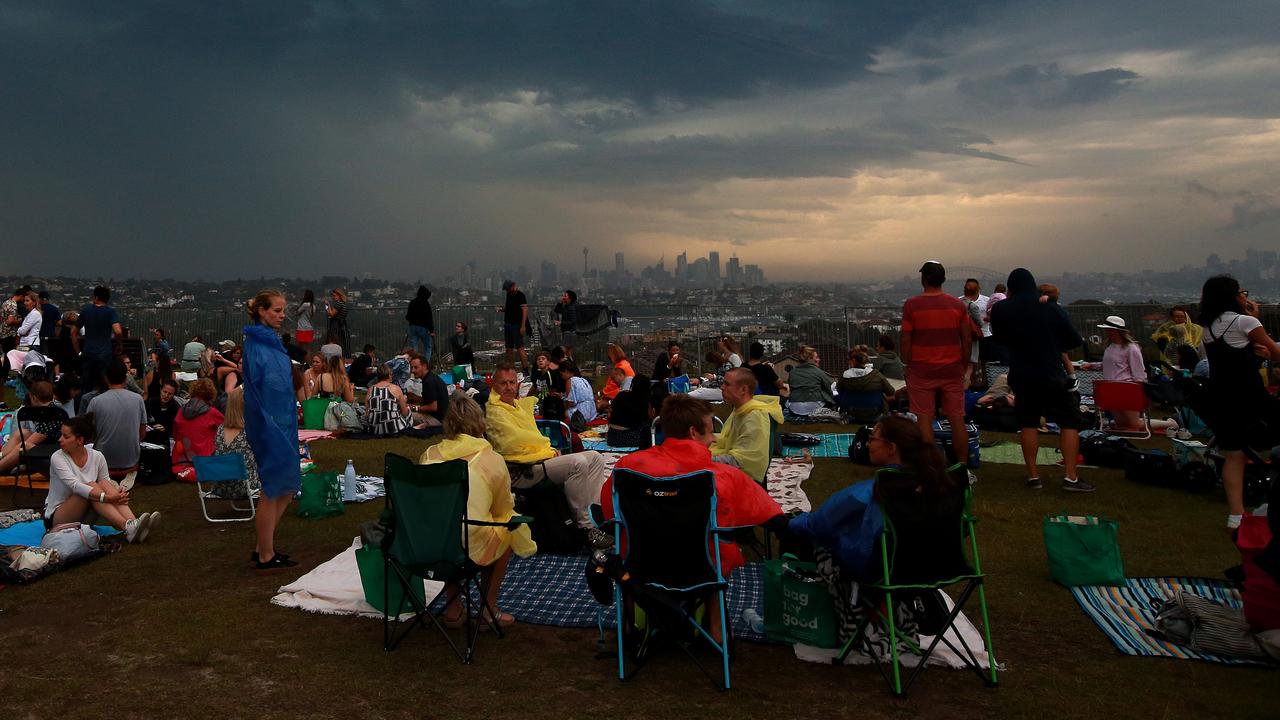 New Years Eve 2018 - 9pm Fireworks display from Dudley Page Reserve in Dover Height. Revellers prepare for rain as a storm front moves through. Picture: Toby Zerna