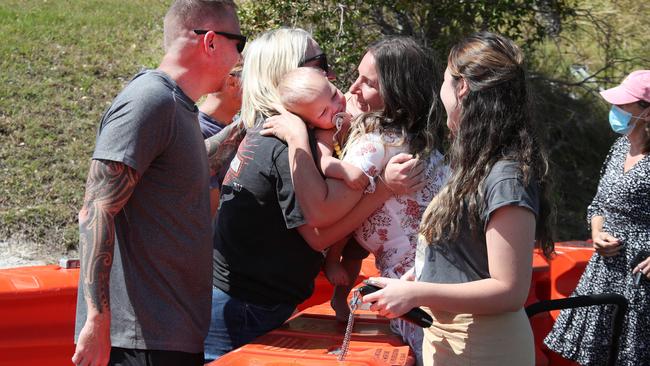 Seperated sisters Chloe Rabinski and Kirsten Chambelain meet over the border wall with their families. Left to right, Jason Hastings, Chloe Rabinski, Django Neil (1 month old) Kirsten Chamberlain and Ava Chamberlain 15. Picture: Glenn Hampson