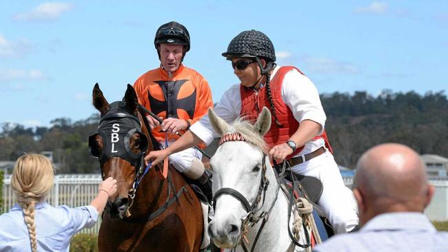 TREBLE TIME: Jockey Jim Byrne is led into the Ipswich enclosure aboard Tough One, the first of his three wins last Friday. Picture: Rob Williams