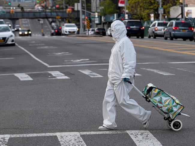 A New Yorker with groceries protects herself against the virus. Picture: AFP