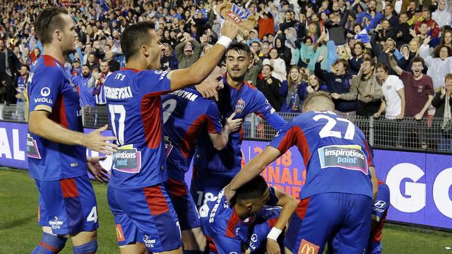 Newcastle Jets players celebrate Jason Hoffman’s goal against Melbourne City.