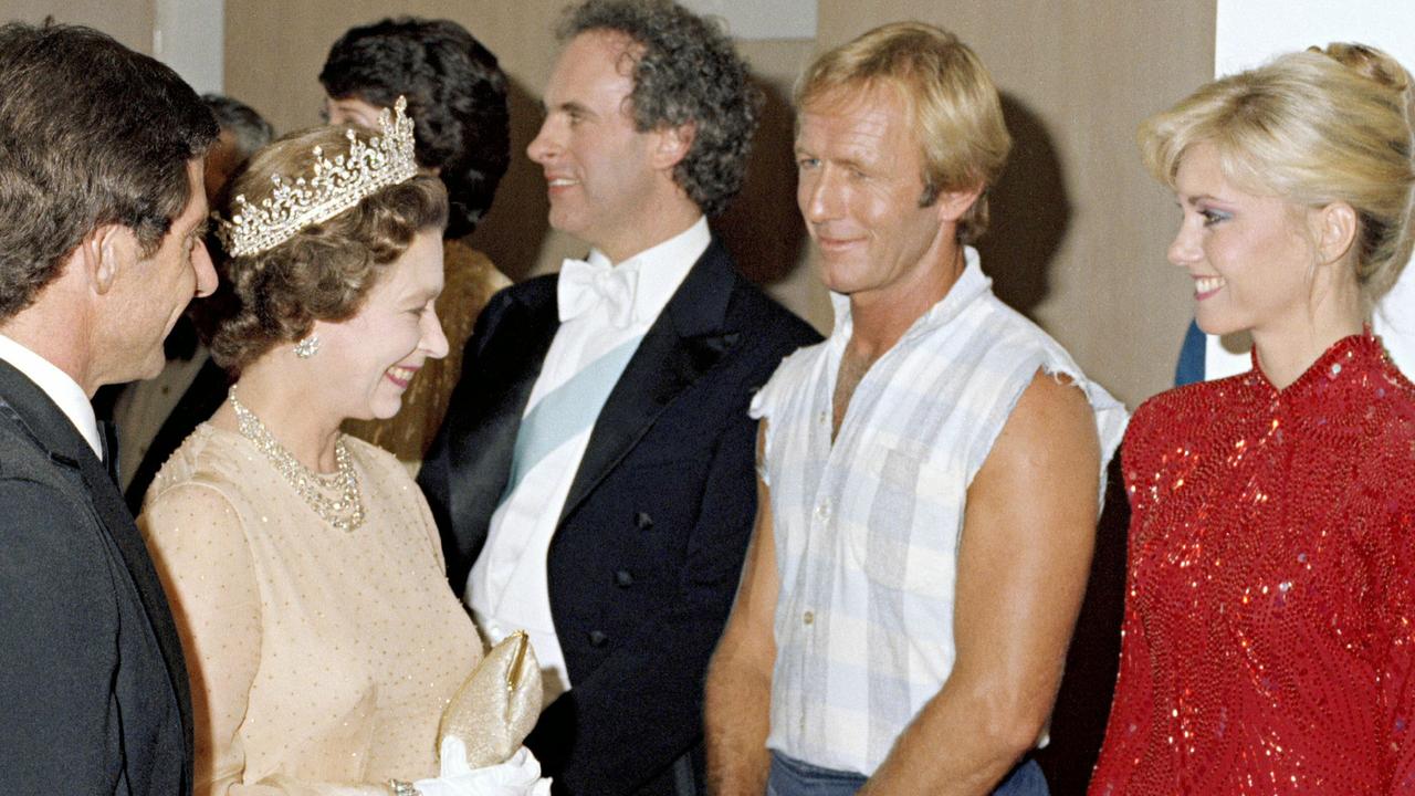 Queen Elizabeth II and the Duke of Edinburgh meet Australian entertainers including (L-R) pianist Roger Woodward, comedian Paul Hogan and singer Olivia Newton-John, after they performed in a Royal Charity Concert at the Sydney Opera House in a 1980 photo. Pic Must Credit National Archives.