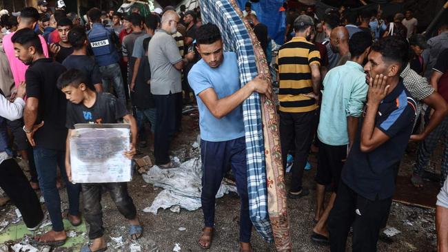 Palestinians react after an Israeli strike hit the Rafida school housing displaced people in Deir al-Balah in the central Gaza Strip on Thursday. Picture: AFP