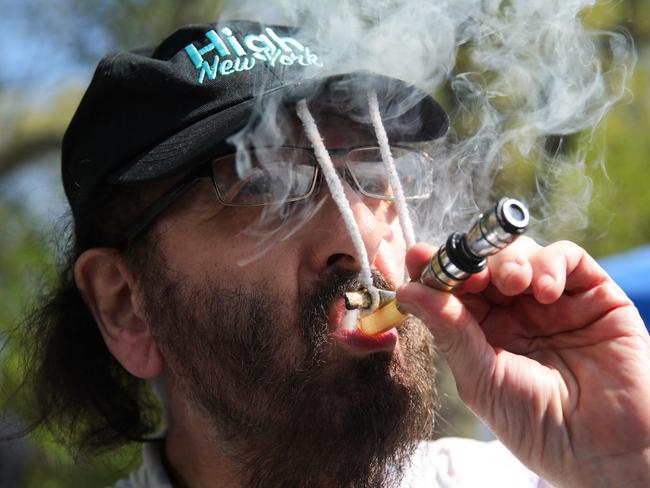 A person smokes marijuana during a 420 celebration at Washington Square Park in New York City on April 20, 2024. April 20 is an unofficial international counterculture celebration of cannabis. (Photo by Leonardo Munoz / AFP)