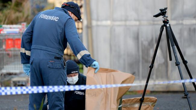 Forensic police at the scene of the stabbing. Picture: Andrew Henshaw