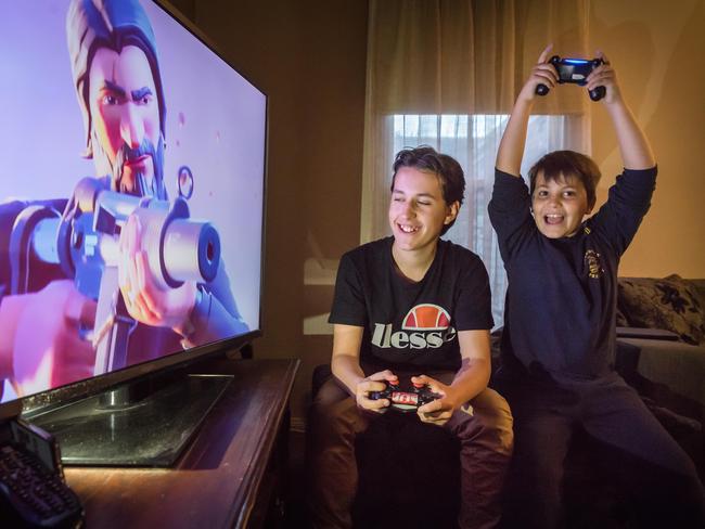 Leroy, 14, and brother Otis, 9, playing Fortnite. Picture: Jason Edwards