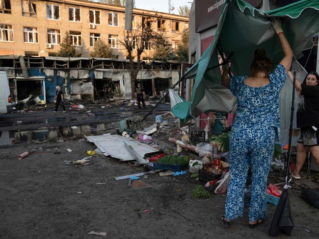 EDITORS NOTE: Graphic content / Women work at the site of a Russian strike at a market in Kostyantynivka, Ukraine's eastern Donetsk region on September 6, 2023, amid the Russian invasion of Ukraine. A Russian strike killed at least 17 people at a market in east Ukraine, officials said, in an attack that President Volodymyr Zelensky described as deliberate and 
