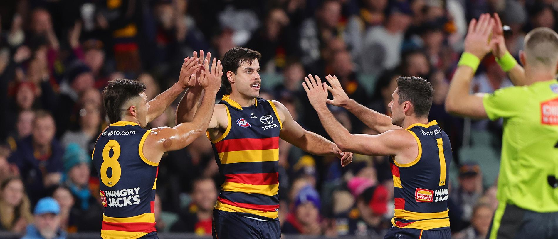 ADELAIDE, AUSTRALIA - MAY 02: Darcy Fogarty of the Crows celebrates a goal with Josh Rachele and Chayce Jones during the 2024 AFL Round 08 match between the Adelaide Crows and the Port Adelaide Power at Adelaide Oval on May 02, 2024 in Adelaide, Australia. (Photo by Sarah Reed/AFL Photos via Getty Images)