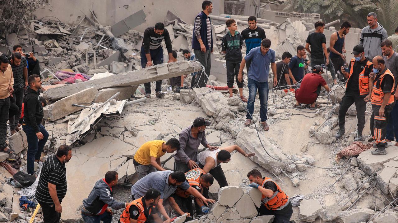 Civilians and rescuers look for survivors amid the rubble of a destroyed building following an Israeli bombardment in Khan Yunis in the southern Gaza Strip. Picture: AFP