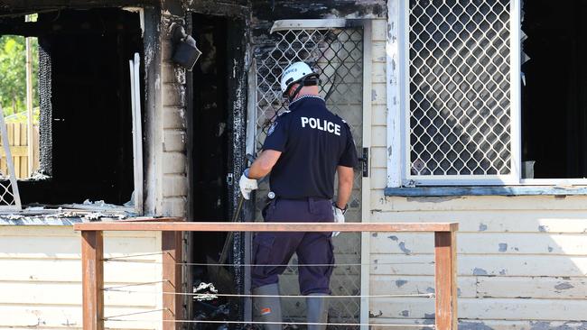 A police investigator enters the home. Picture: Tertius Pickard