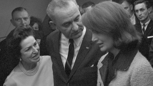 Lady Bird and US President Lyndon B Johnson talking to first lady Jacqueline Kennedy after Johnson was sworn in as president on Air Force One in Dallas.