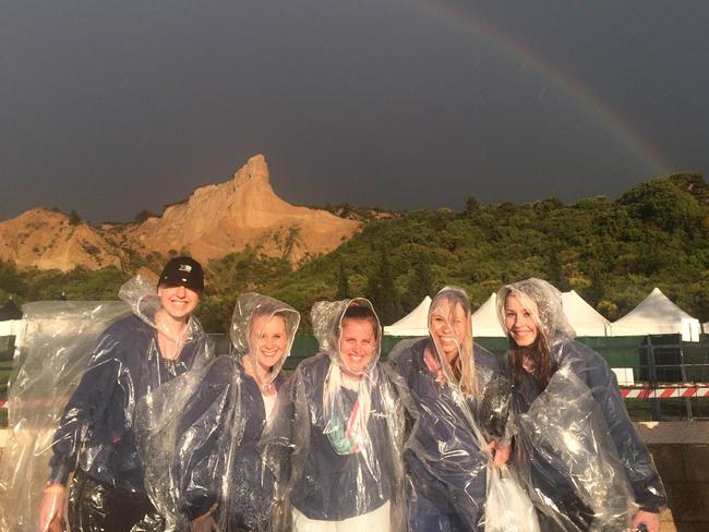 Australians Jessica Walmsley, Sarah Brown, Alice Morrissey, Alyce Clark and Samantha Clark brave the rain ahead of the Anzac Day Dawn Service. Picture: Ella Pellegrini