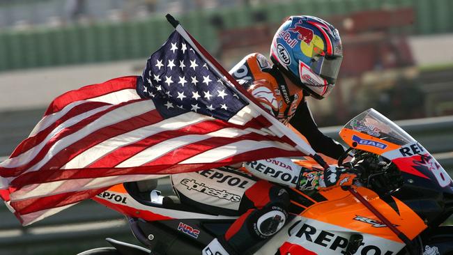 FILE — In this Oct. 29, 2006, file photo, United States Honda rider Nicky Hayden holds a U.S. flag after winning the world championship GP at the Cheste racetrack near Valencia, Spain. The Maurizio Bufalini Hospital has announced that American motorcycle racer Nicky Hayden has died, five days after being hit by a car while training on his bicycle Hayden was 35. (AP Photo/Bernat Armangue, File)