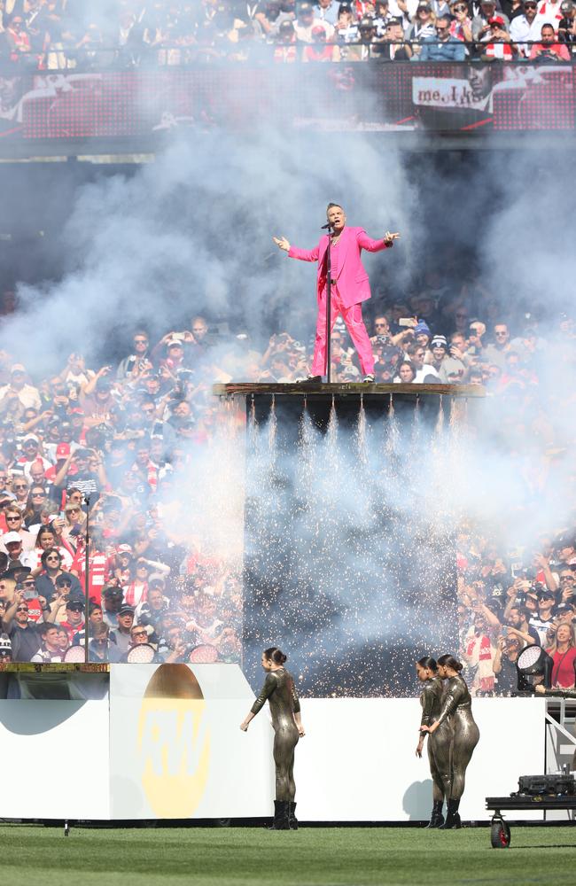 Robbie Williams was smokin’ hot in his pink suit as he sang the packed crowd at the MCG. Picture: David Caird