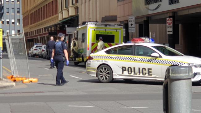 Police escort an individual from Peppers Hotel in Waymouth St. Picture: Colin James