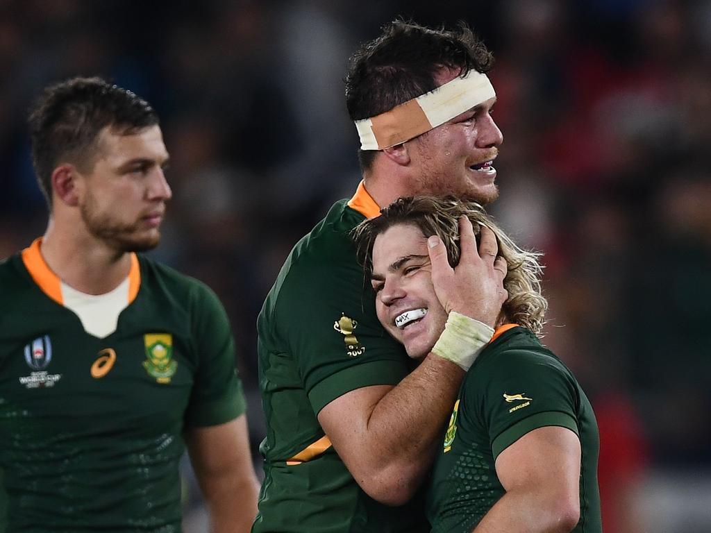 Francois Louw hugs Faf de Klerk. (Photo by CHARLY TRIBALLEAU / AFP)