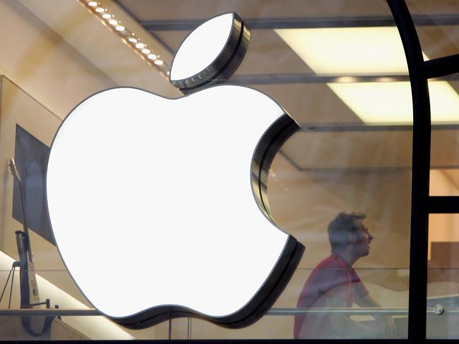 FILE - SEPTEMBER 21: According to reports Apple has approached McLaren, the British super-car maker and Formula One team owner about a potential acquisition. LONDON - DECEMBER 27: People are seen behind the Apple logo in Apple's flagship London retail store on Regent Street on December 27, 2006 in London, England. With many stores open for the first time since Christmas Eve, bargain hunters are searching for the best buys as the post-Christmas sales get under way. (Photo by Scott Barbour/Getty Images)